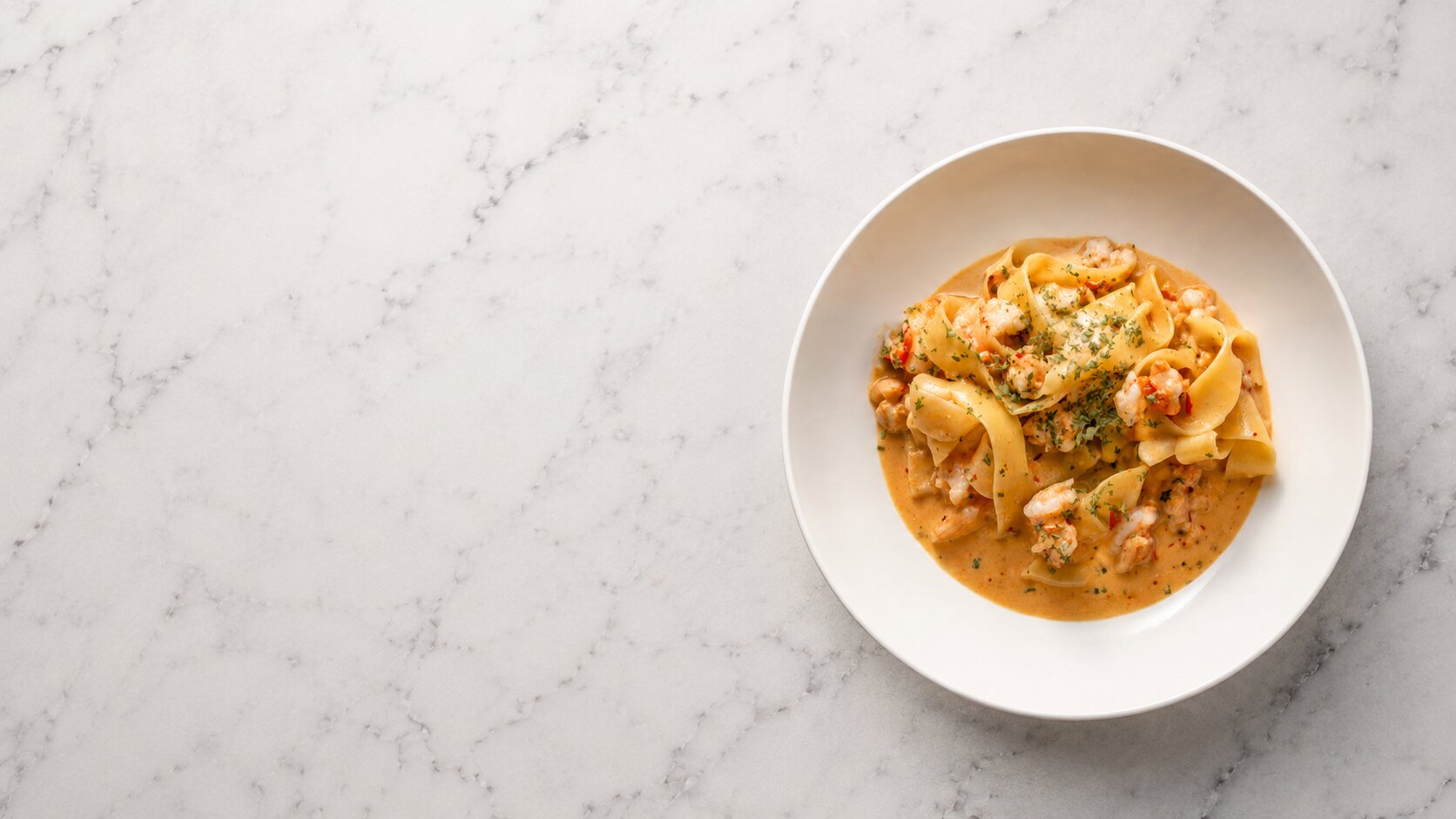Pasta in a bowl on a marble table top