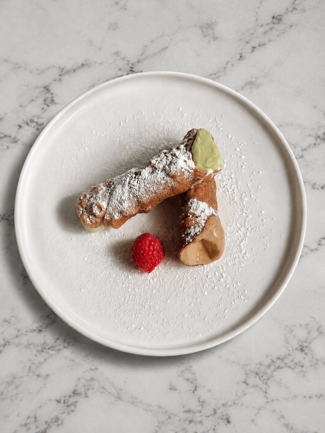 Homemade cannoli filled with pistachio and and coffee cream